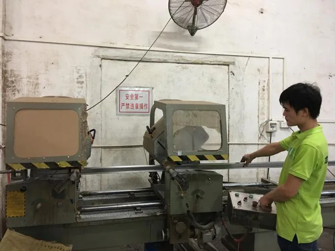 Worker preparing aluminum profiles for partition system production
